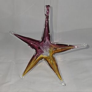 This is a hand-blown glass star ornament or suncatcher